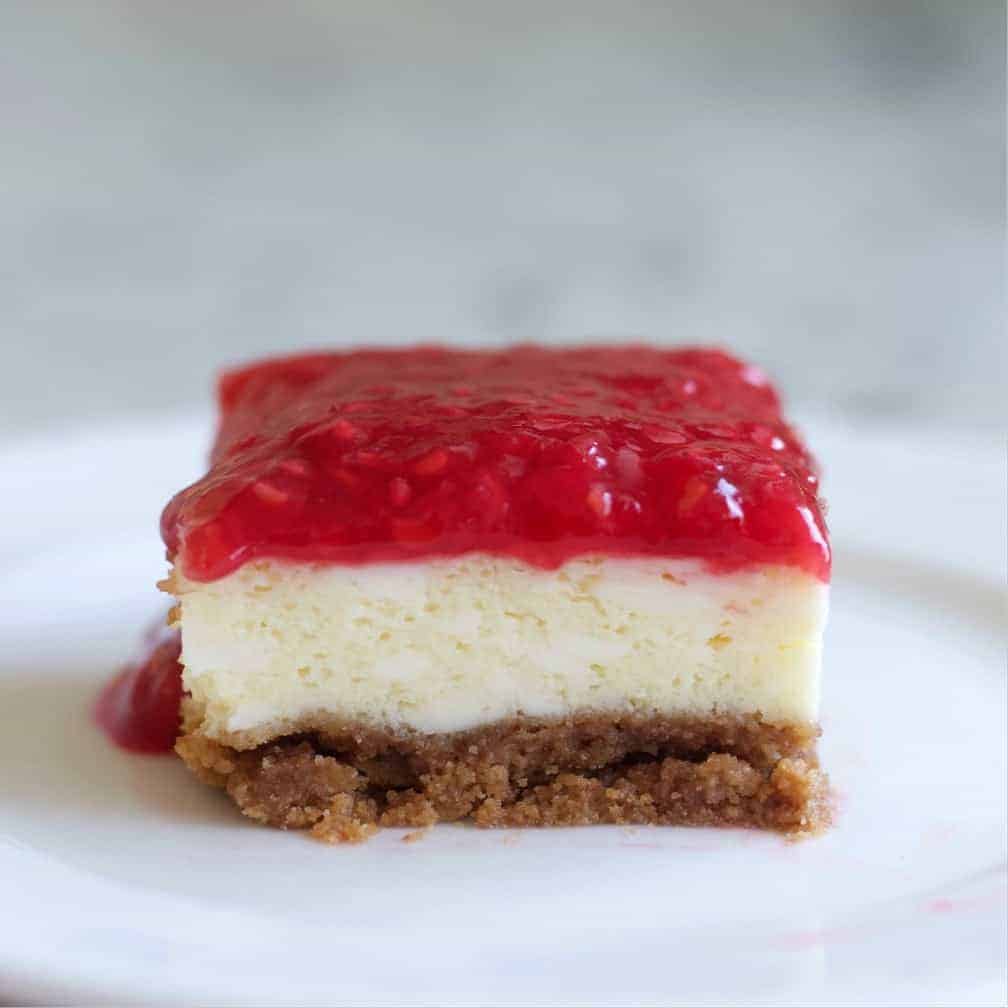Raspberry Cheesecake Square Cut On A Plate.