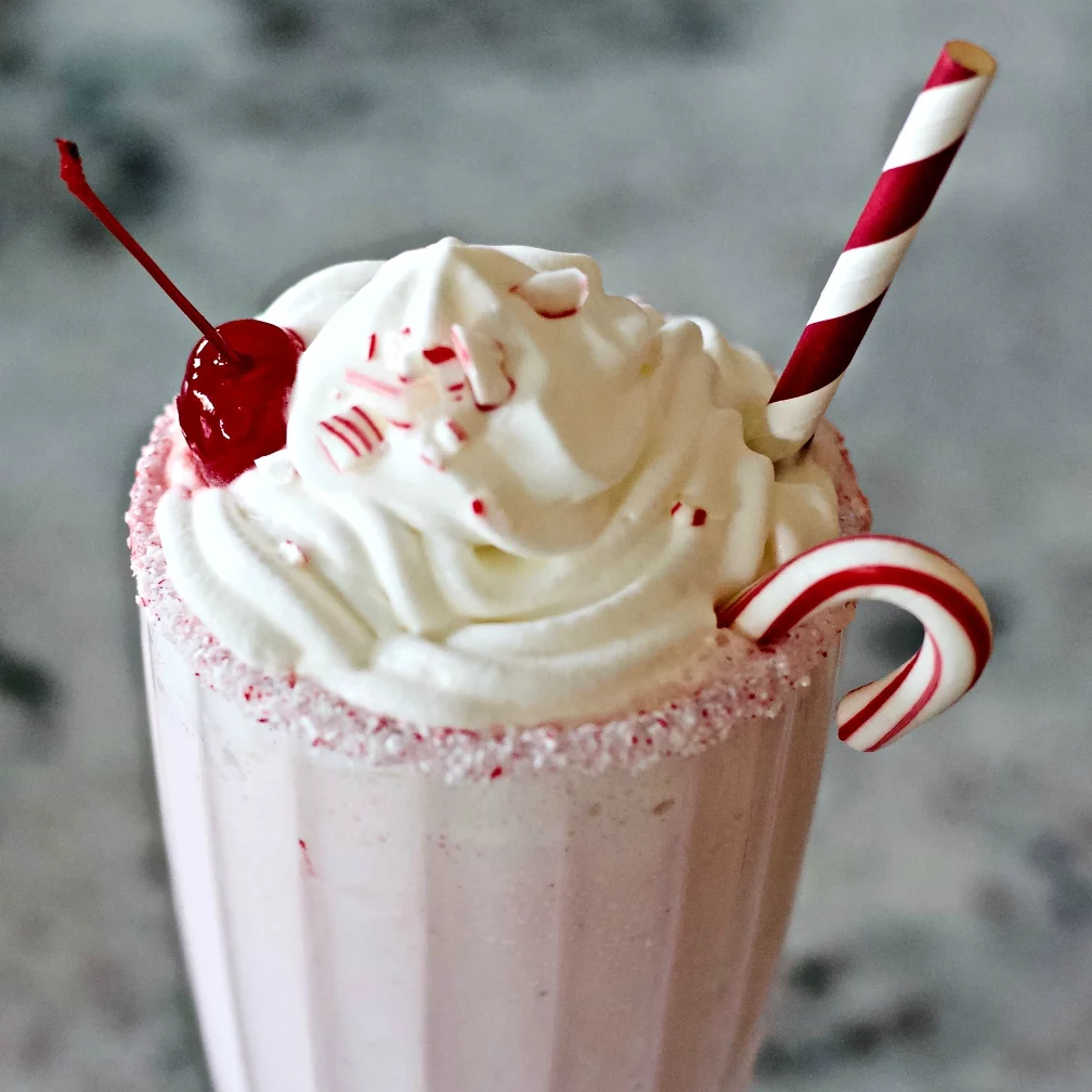 Peppermint Milkshake Garnish. Whipped Cream, A Candied Cherry, Crushed Peppermint Candy, A Mini Candy Cane And A Candy Cane Paper Straw.