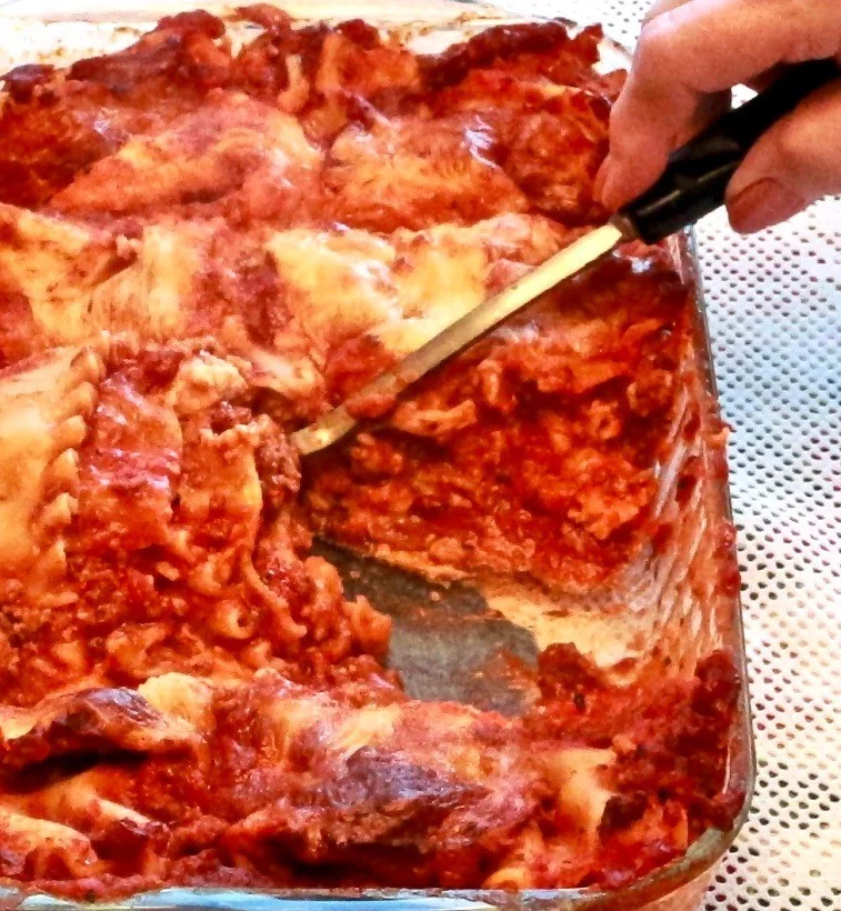 Homemade Five Cheese Lasagna Recipe 1 shown is our Homemade five cheese Lasagna recipe in a casserole with a serving spoon