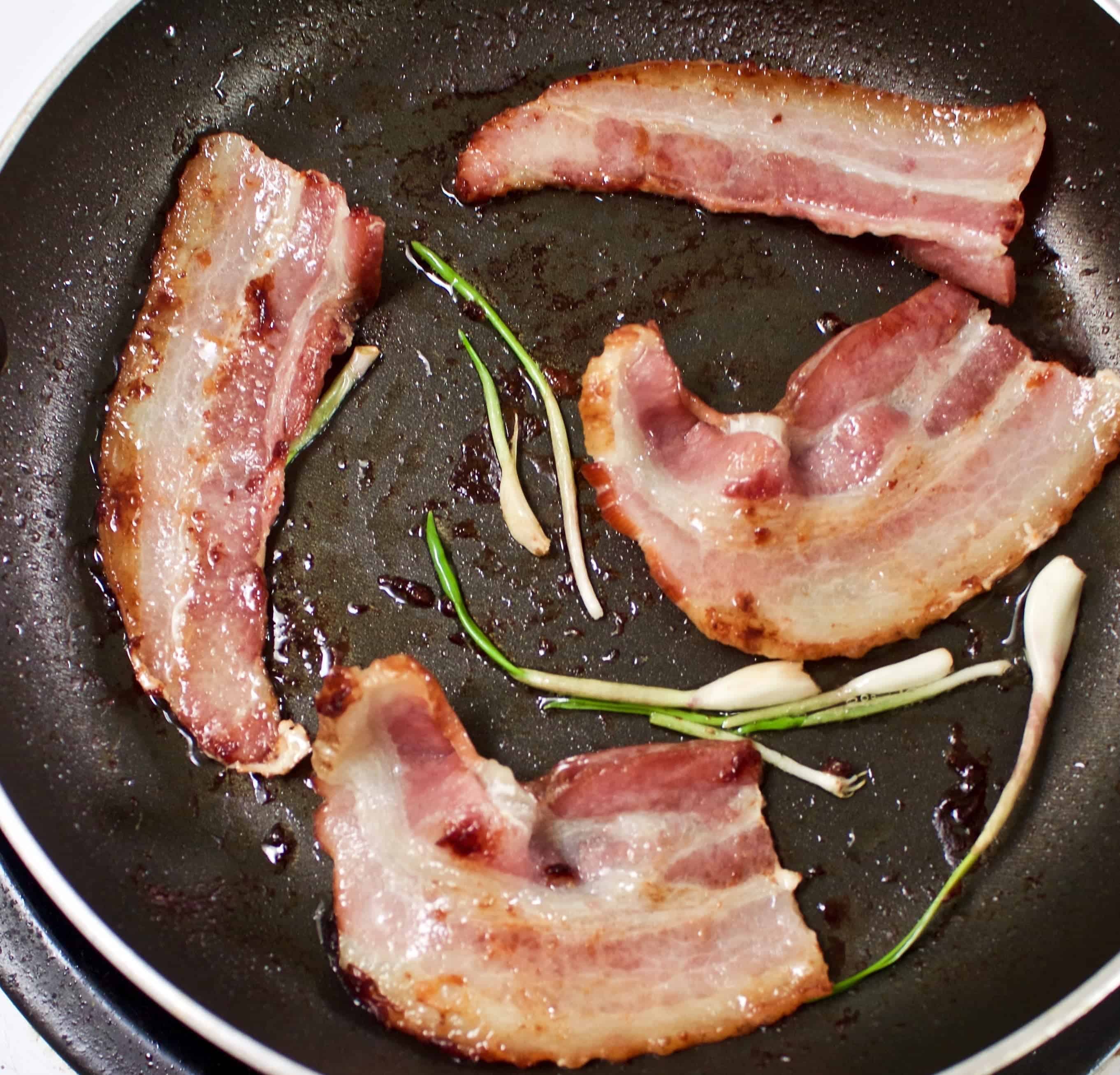 Frying Bacon With Garlic Sprouts