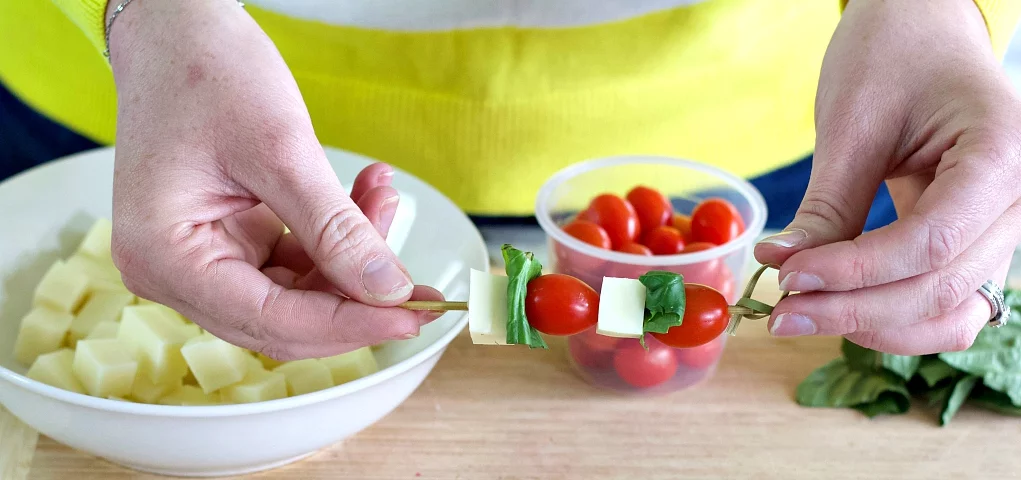 Holding The Finished Caprese Bite.