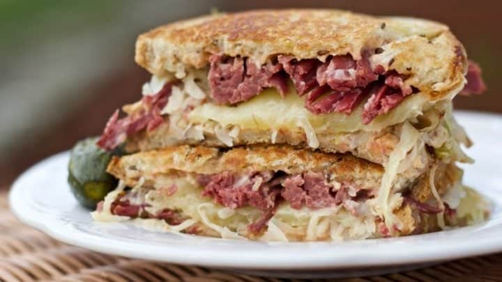 Reuben Sandwich Is A Favorite American Sandwich. Piquant Combination Of Swiss Cheese, Corned Beef, Sauerkrau