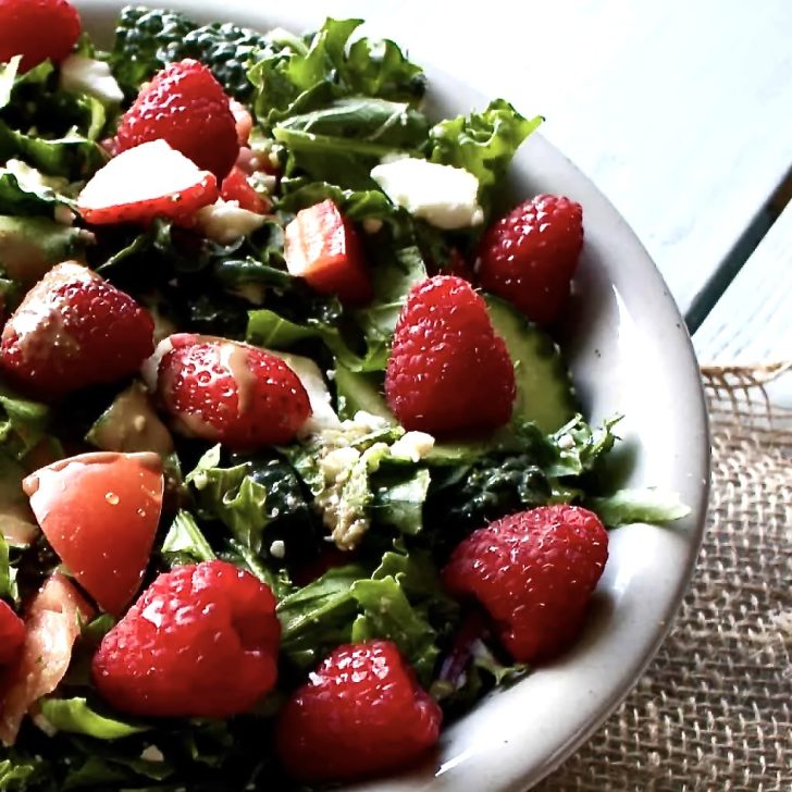 garden berry salad in a grey stoneware bowl on a piece of burlap