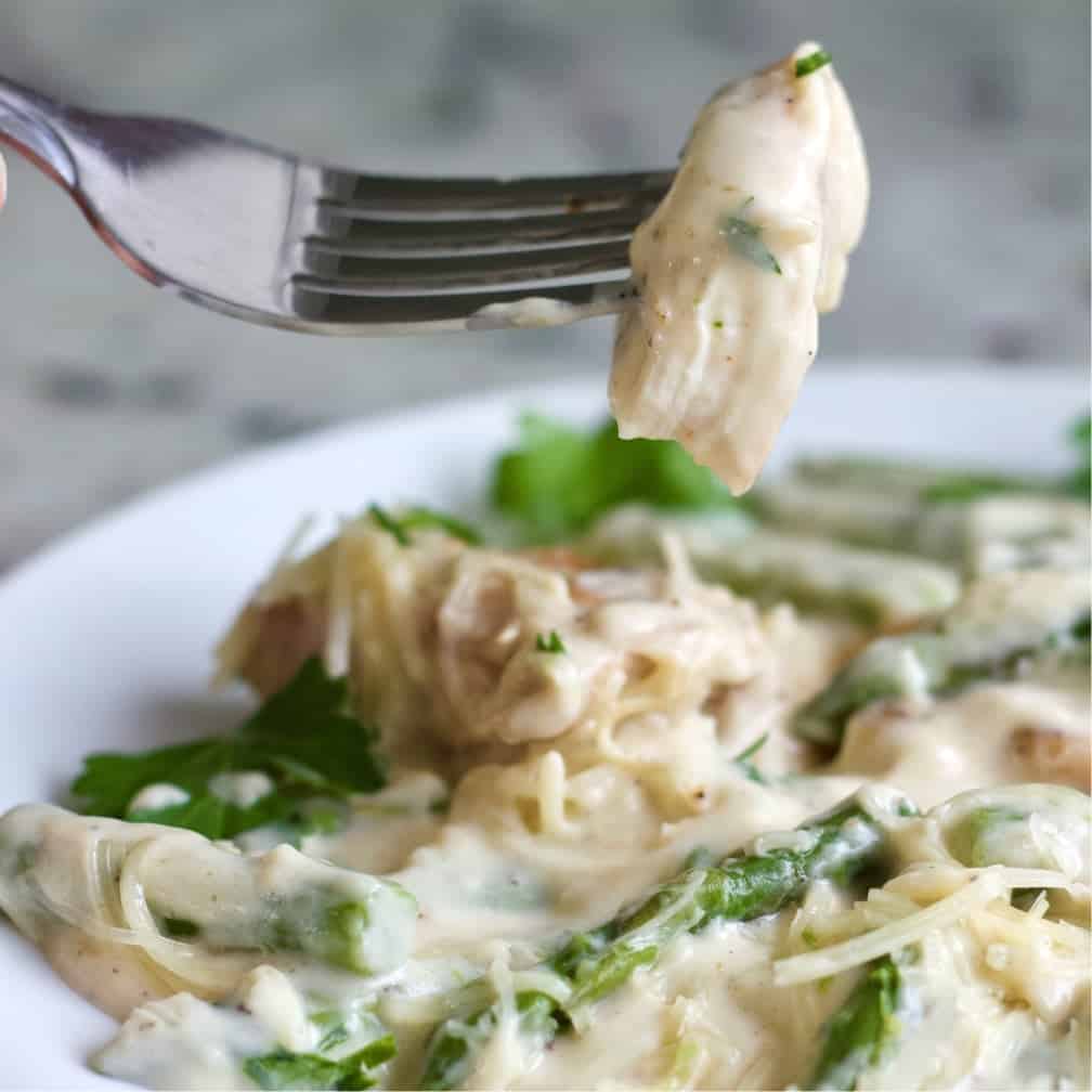 Chicken Alfredo Asparagus Dinner Serving With A Forkful Of Creamy Coated Chicken.
