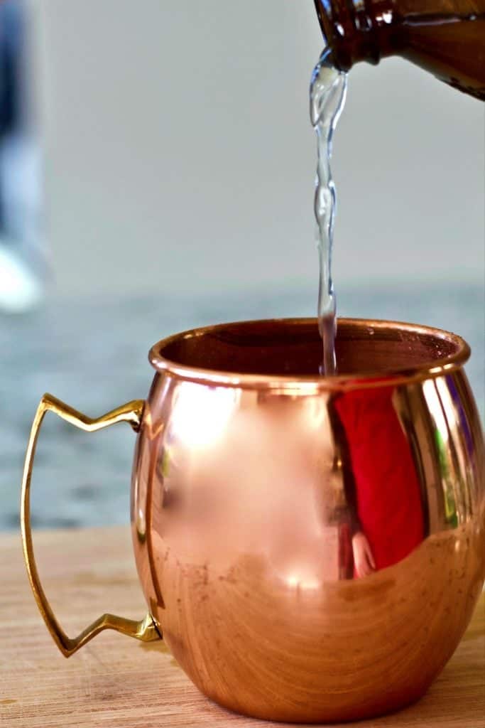 Moscow Mule Vodka Drink Recipe 5 Pouring Vodka Into A Copper Mug