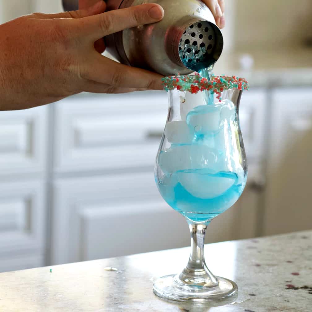 Pouring The Shaker Ingredients Into The Glass.