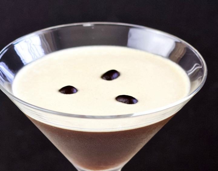 espresso martini with three coffee beans on top.