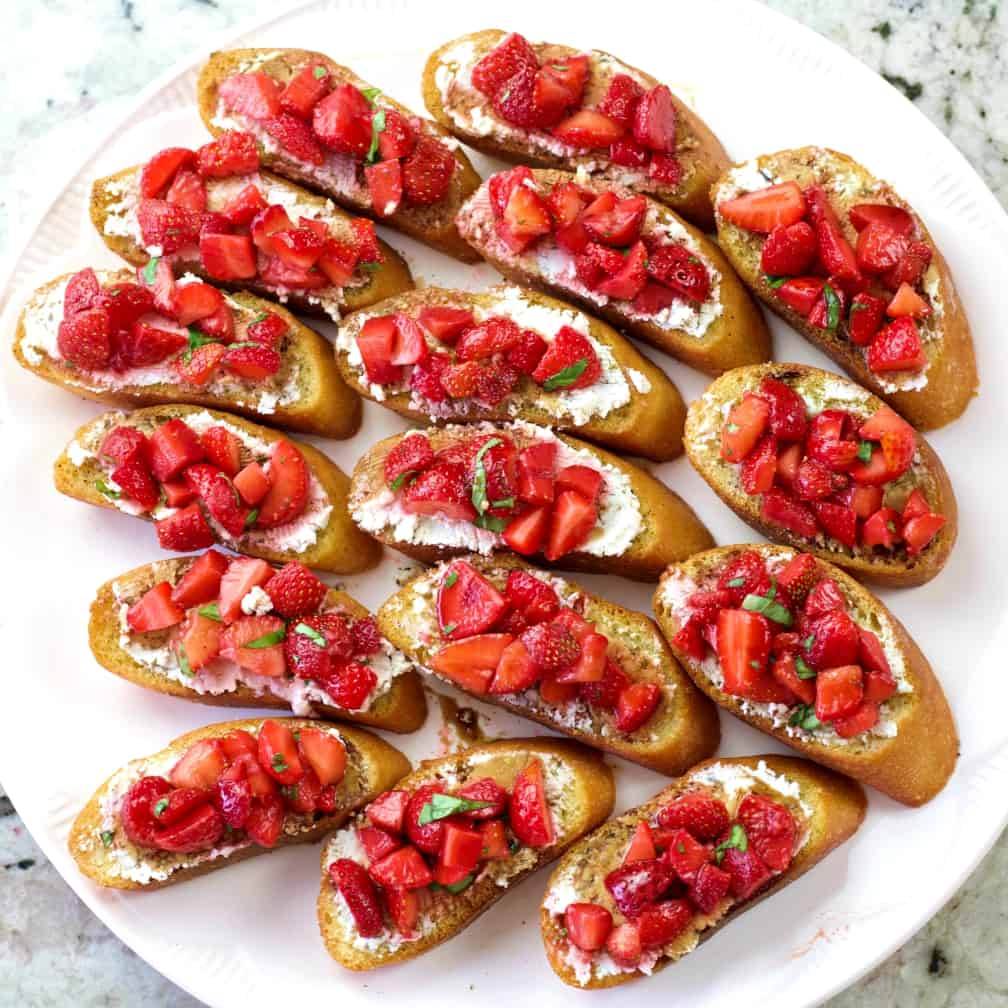 A Tray Full Of Strawberry Basil Bruschetta Recipe With Goat Cheese