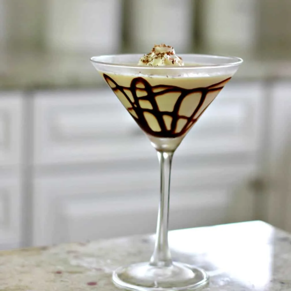 Baileys Mudslide Vodka Martini Recipe 5 Martini Glass With Chocolate Sauce Lines In The Glass And Whipped Cream On Top With Shaved Chocolate.