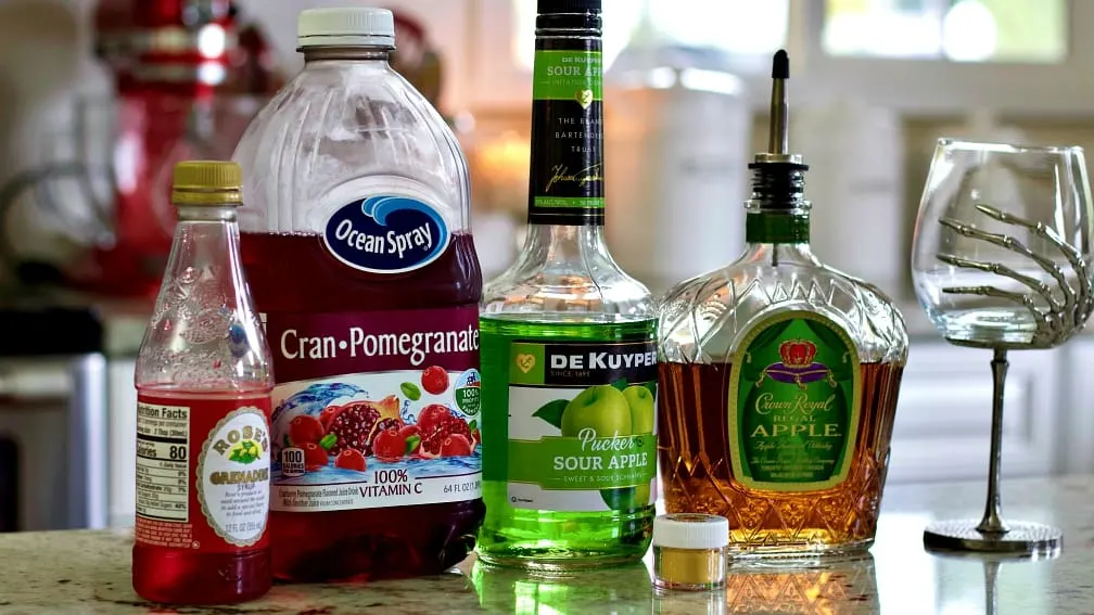 Sour Apple Pucker, Crown Royal Apple And Other Ingredients For The Poison Apple Sitting On The Counter