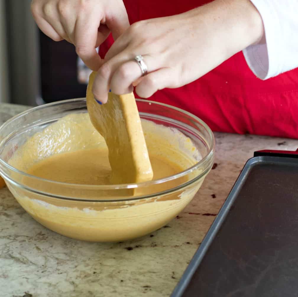 Sliding Excess Batter Off The Bread With Fingers