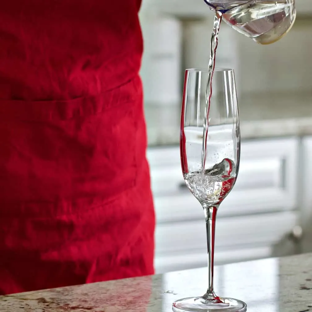 Pouring White Cranberry Juice Into A Champagne Flute