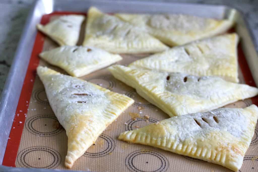 Freshly Baked Apple Turnovers On A Baking Sheet.