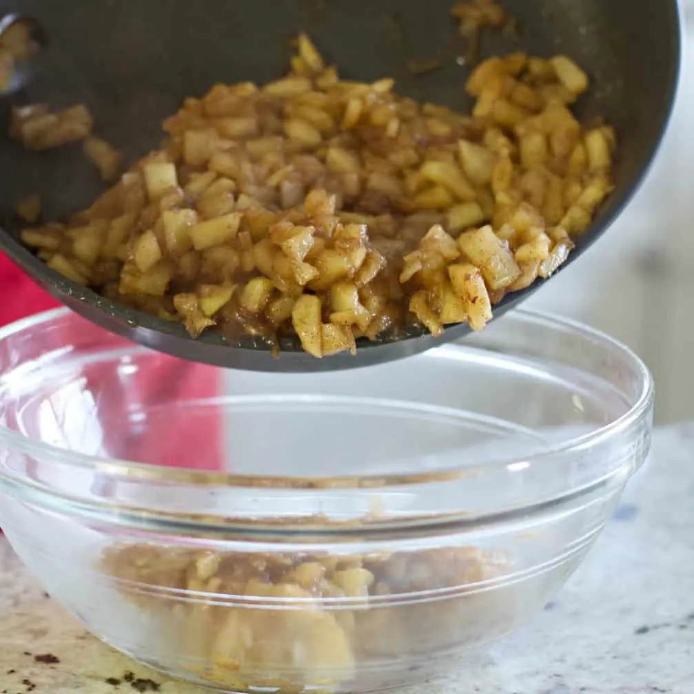 Pouring Hot Cooked Apples Into Bowl