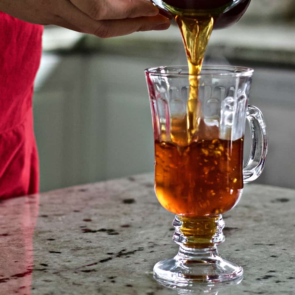 Pouring Hot Coffee Into A Clear Mug.