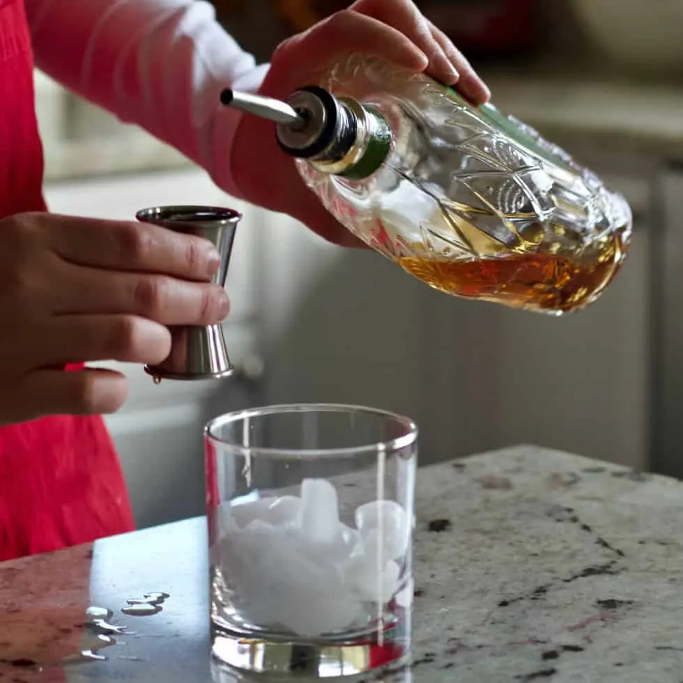 Pouring Crown Apple Whiskey Into A Jigger