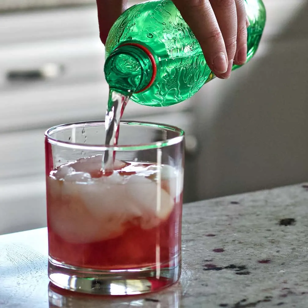 Cranberry Apple Whiskey Cocktail Recipe 10 Pouring 7Up Into Drink