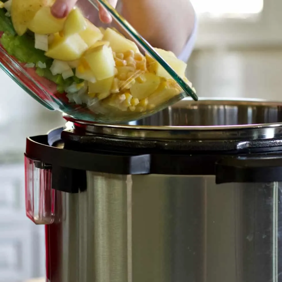 Pouring Vegetables Into Instant Pot-Chicken Soup