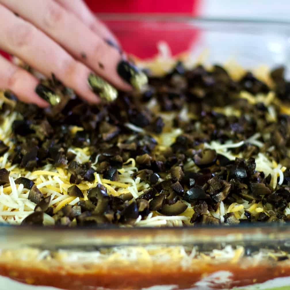 Spread Olives Over Cheese Layer.