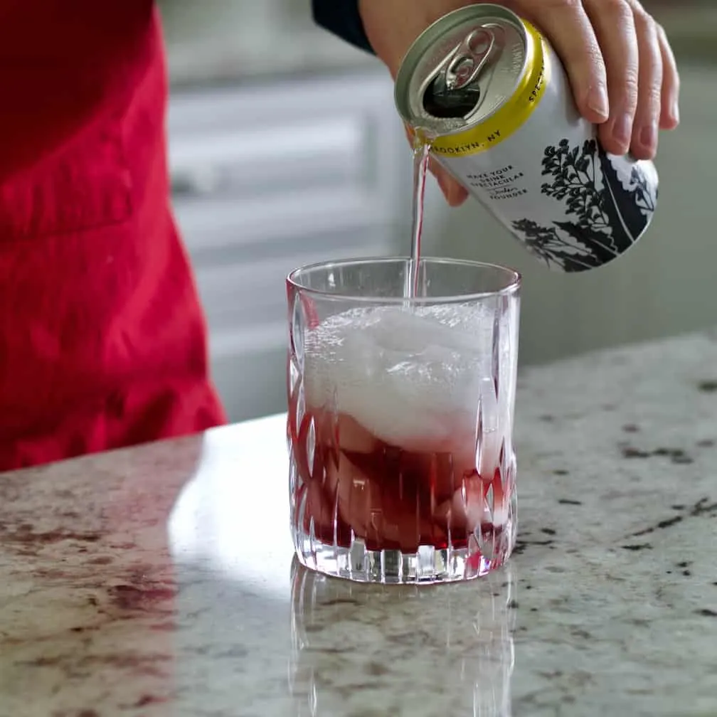 Pouring Tonic Water In Cocktail
