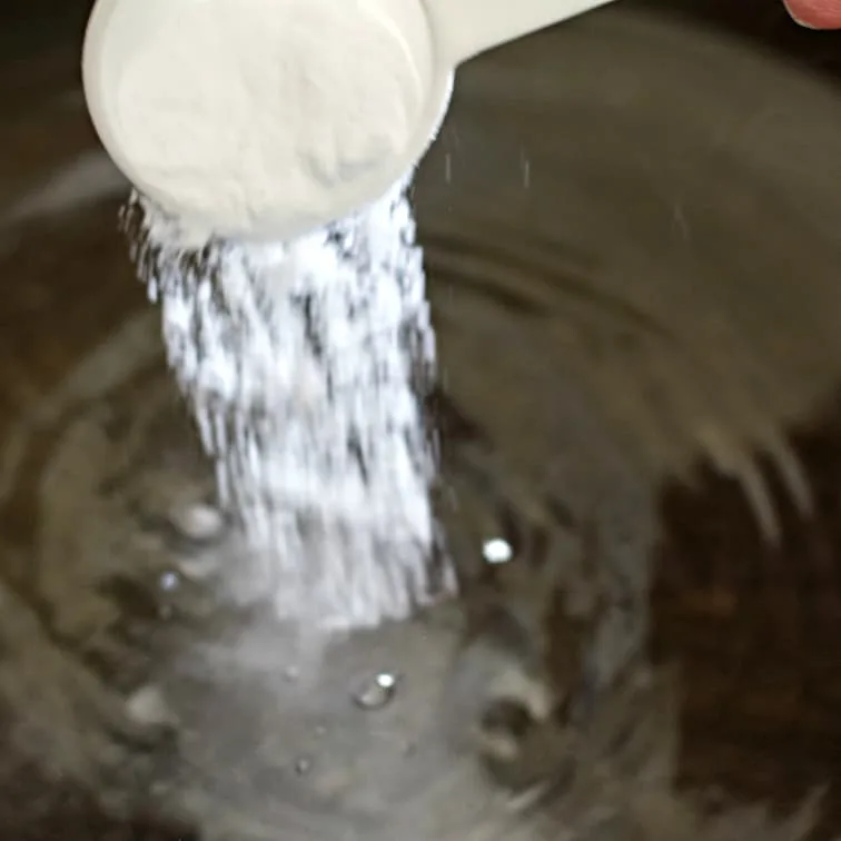 Pouring Baking Soda For Boiling Bagels