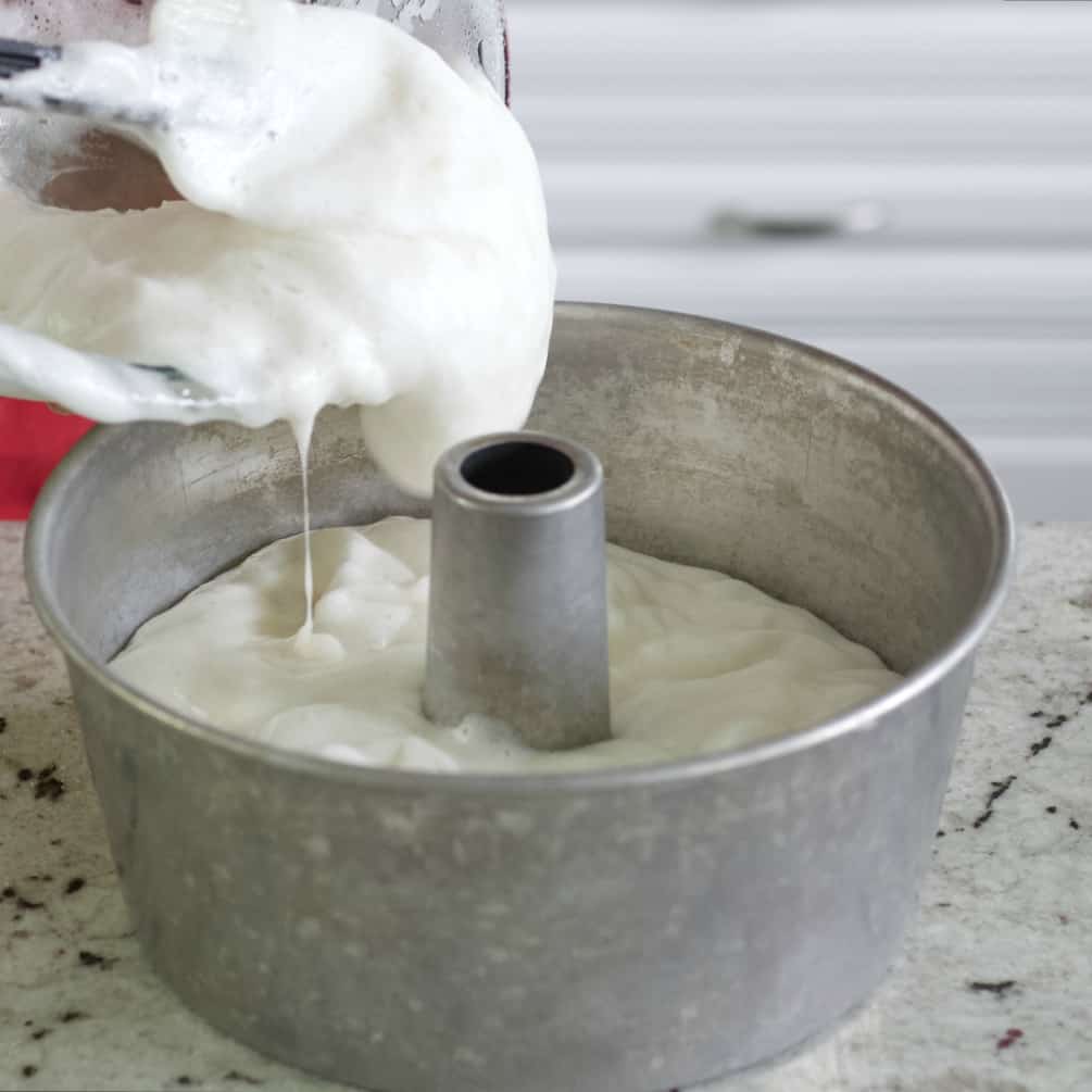 Pouring Angel Cake Batter Into Tube Pan.