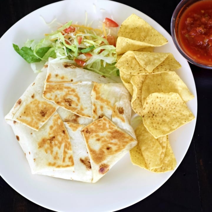 Crunchwrap supreme top shot with tortilla chips and salsa