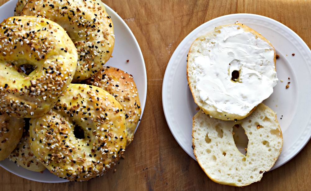 Homemade Two Ingredient Bagels Recipe 2 Cream Cheese On Cut Bagel Half With Stack Of Bagels