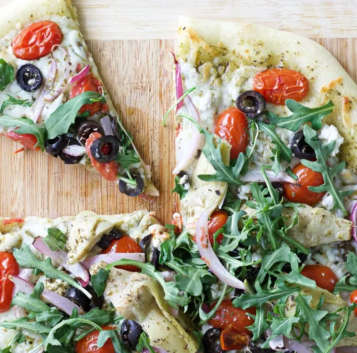 Flatbread with Mediterranean toppings cut slice
