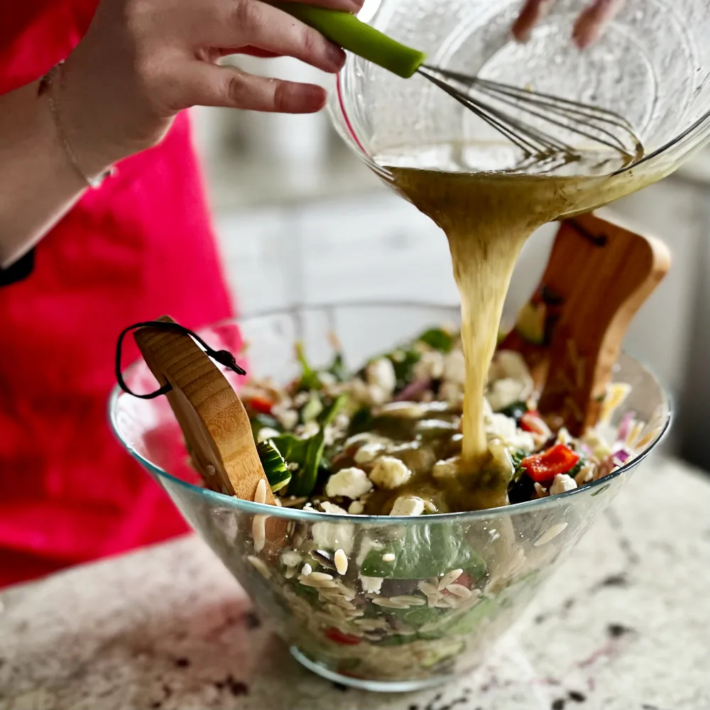Pouring Dressing On Orzo Salad