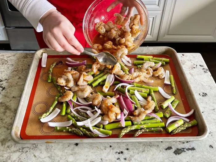 Spooning Shrimp Over Veggies On Sheet Pan