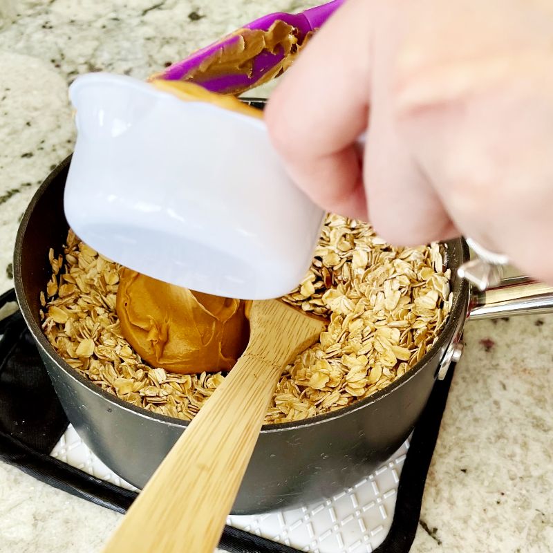 Adding Peanut Butter,Vanilla And Oatmeal To Finish Cookies.