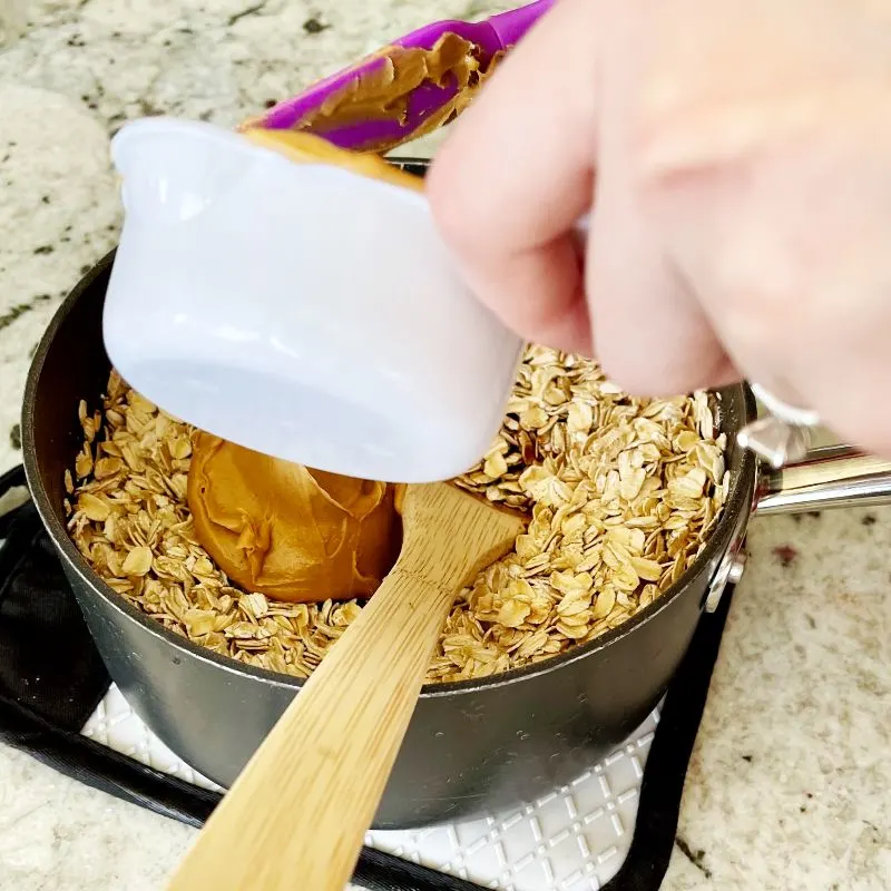 Adding Peanut Butter,Vanilla And Oatmeal To Finish Cookies.