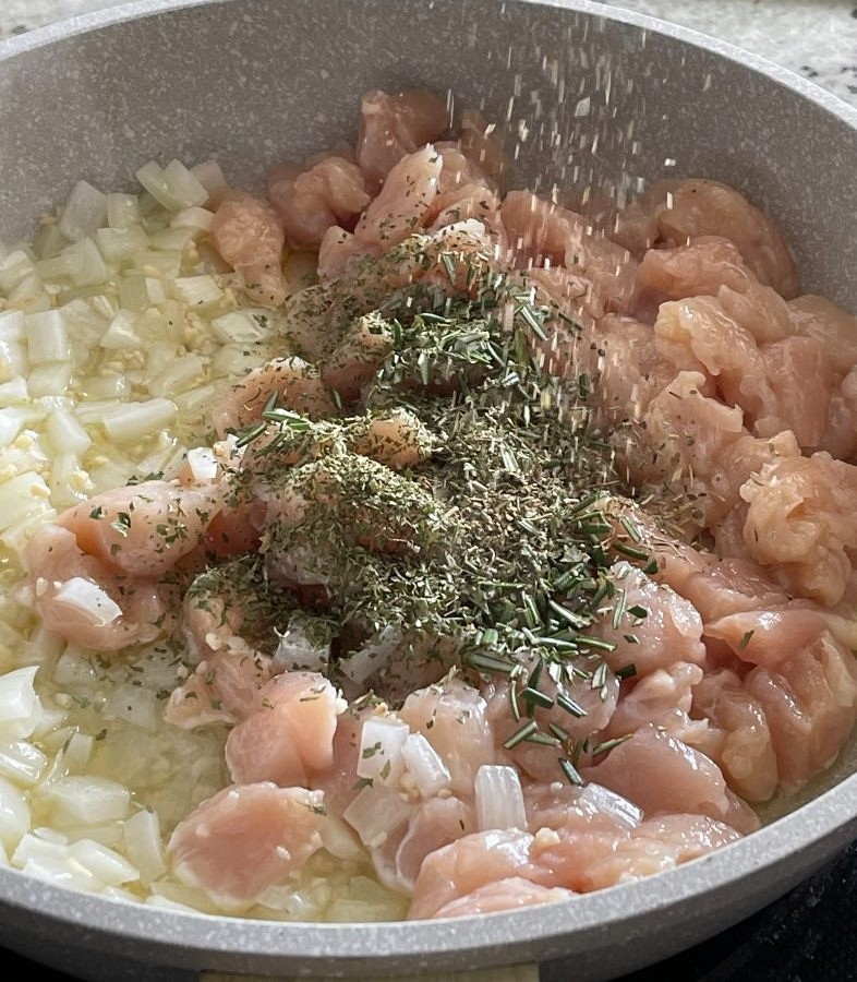 SautÉ Chicken Onion Garlic And Seasonings In Skillet
