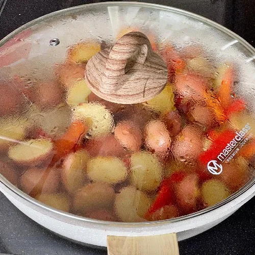 Frying Sausage And Potatoes