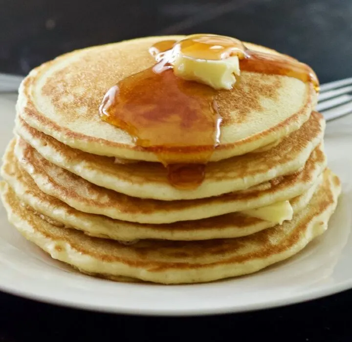 stack of sourdough pancakes with butter and syrup
