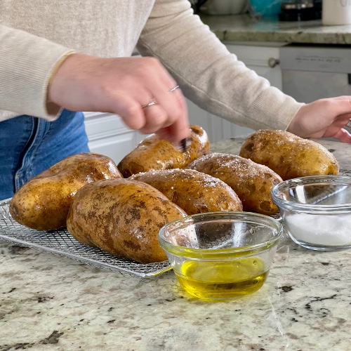 sprinkling oiled potatoes