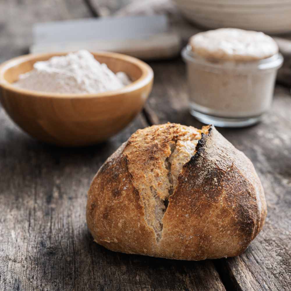 Why Is Sourdough Bread Good For You? Whole Wheat Sourdough Bread And Starter Pictured.