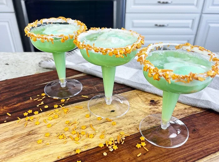 Glasses, Straws And Punch In Glass Dispenser On Garden Table