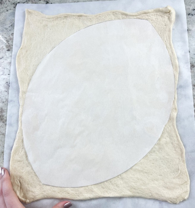 Placed Parchment Cut Out On The Pizza Crust. Ready To Shape The Pizza.
