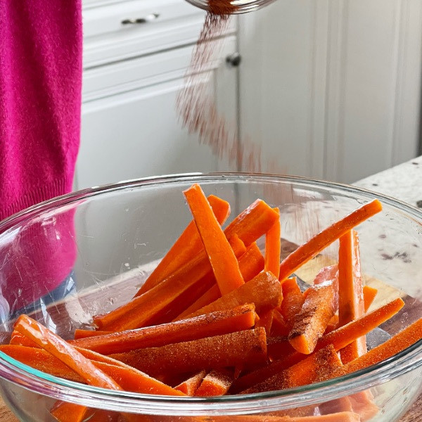 Seasoning Raw Carrots In Bowl