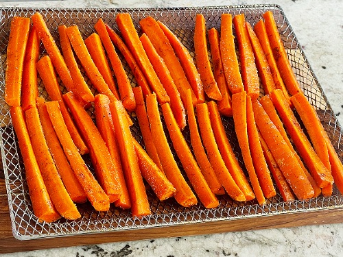 Raw Seasoned Carrots On Air Fryer Tray