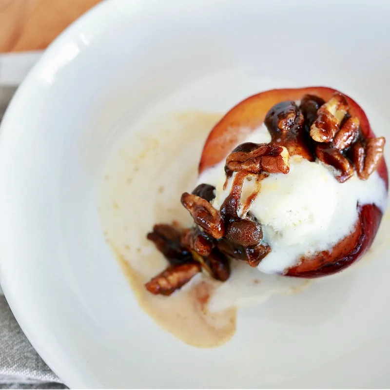 Candied Pecans And Ice Cream Over Fried Peach Dessert