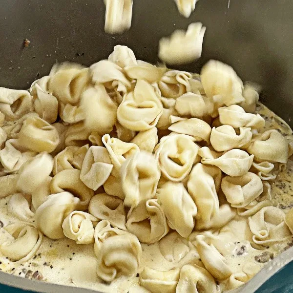 Adding Cheese Tortellini To Creamy Tortellini Soup