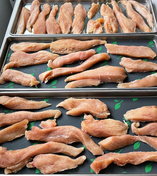Freeze Drying Food Safety: How to Preserve Food Safely at Home 6 raw frozen chicken on trays ready to freeze dry. Good Freeze drying food safety practices are especially important for freeze drying raw meats.