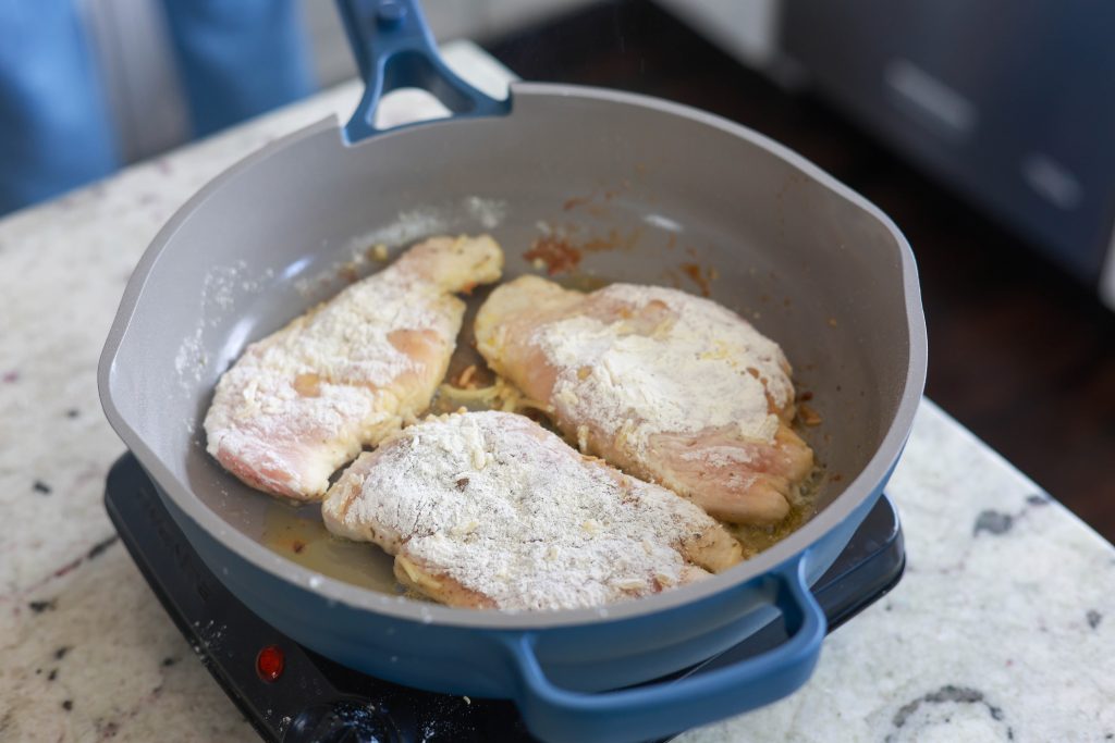 Flour Dredged Chicken Pan Frying For Dinner.