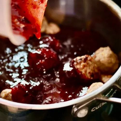Sizzling Hot Honey Cranberry Meatballs 6 Poring Sauce Over Meatballs