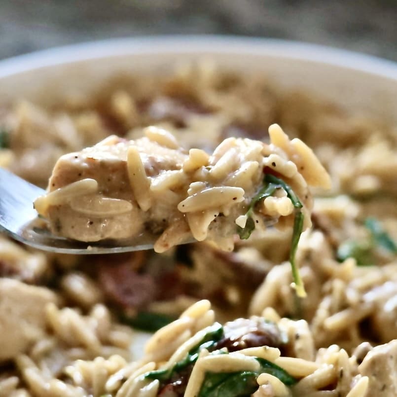 Marry Me Chicken Orzo Skillet Dinner 4 Marry me chicken in a white dish. close up