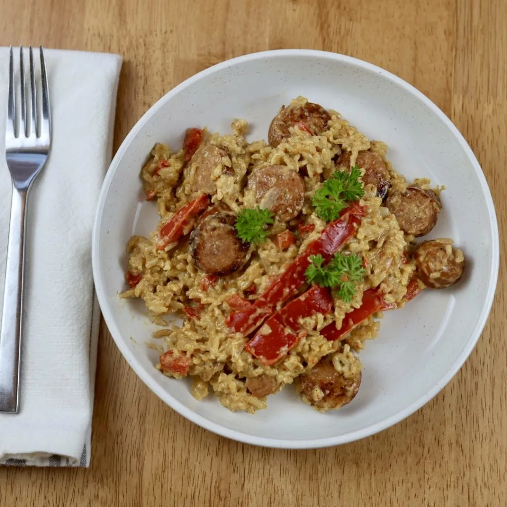 Creamy Cajun Sausage Rice Skillet Meal 5 creamy cajun sausage and rice skillet dinner on a plate with fork