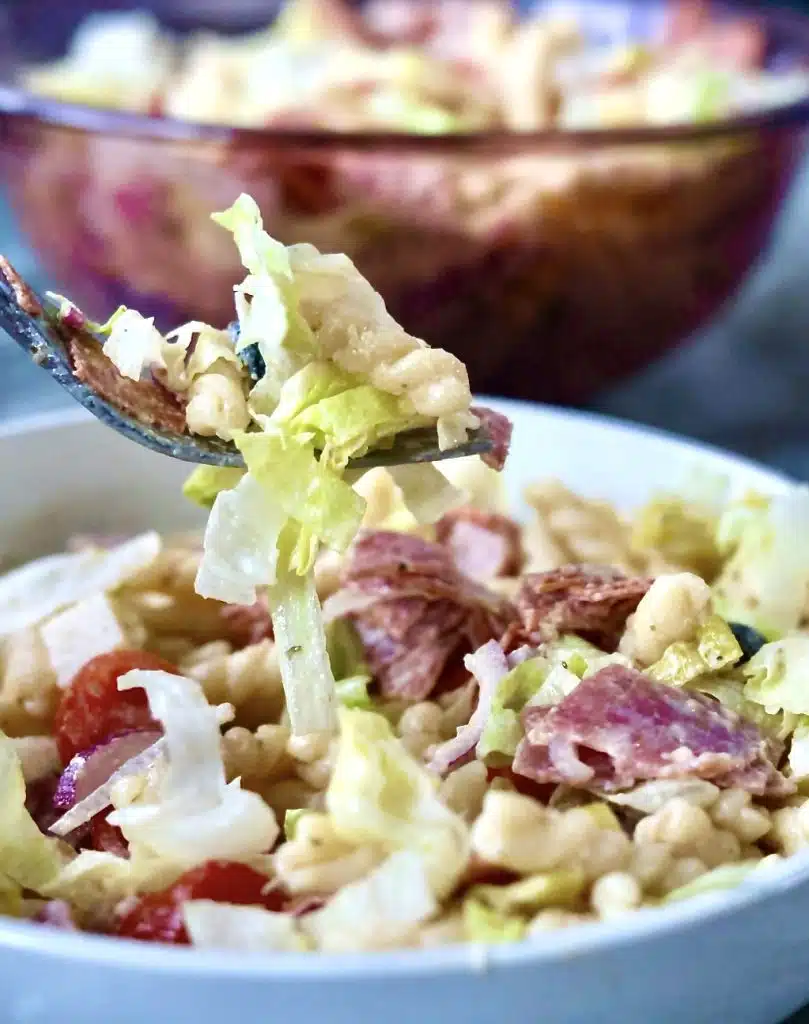 Creamy Italian Grinder Pasta Salad 3 Italian Grinder Pasta Salad close up an oi fork ,over a bowl of salad